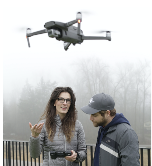A drone instructor teaching man how to use his drone in foggy weather